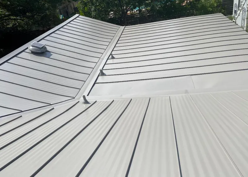 Solar attic fan installed on a metal roof for Roof Ventilation in Plum